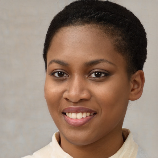 Joyful black young-adult female with short  brown hair and brown eyes