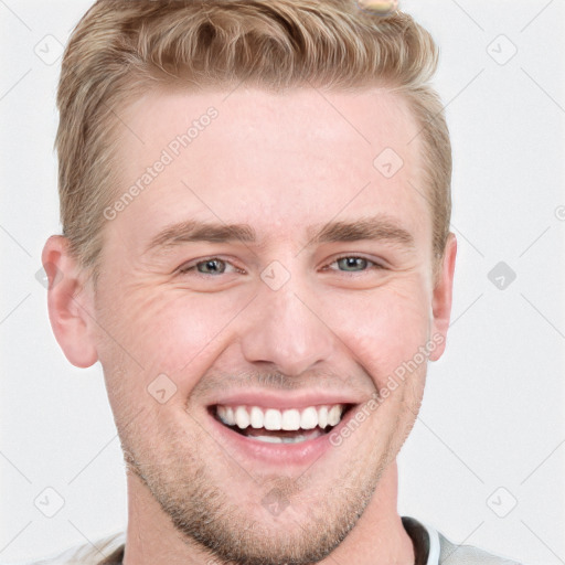 Joyful white young-adult male with short  brown hair and blue eyes