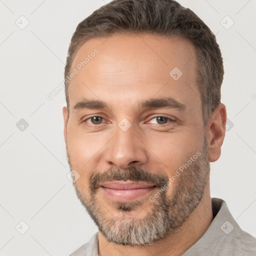 Joyful white adult male with short  brown hair and brown eyes