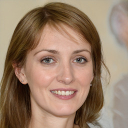 Joyful white young-adult female with medium  brown hair and blue eyes