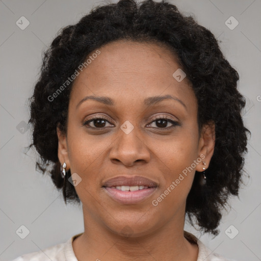 Joyful black adult female with medium  brown hair and brown eyes