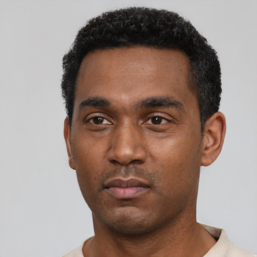 Neutral black young-adult male with short  black hair and brown eyes