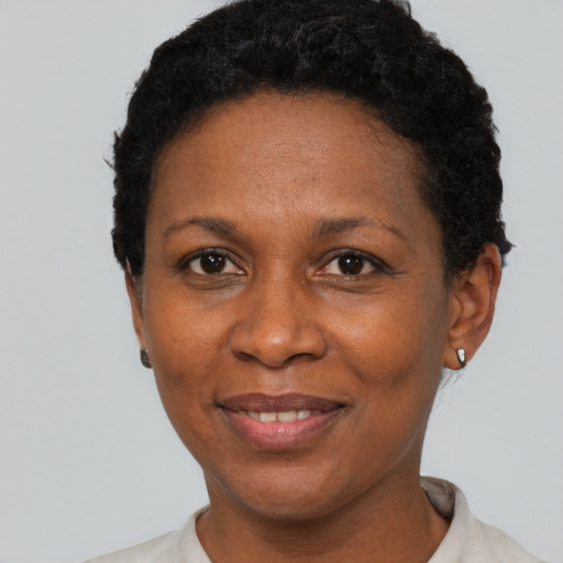 Joyful black adult female with short  black hair and brown eyes