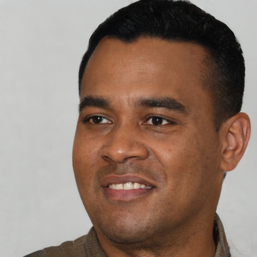 Joyful black young-adult male with short  black hair and brown eyes