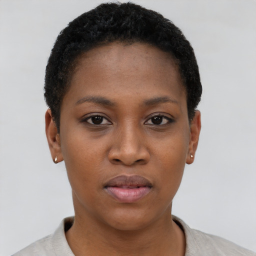 Joyful black young-adult female with short  black hair and brown eyes