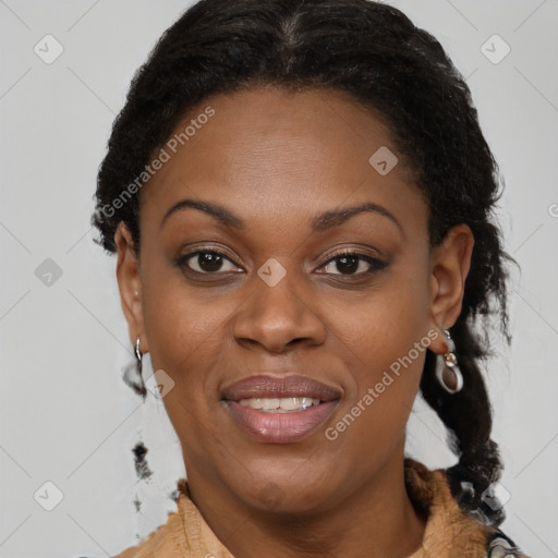 Joyful black adult female with medium  brown hair and brown eyes