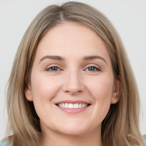 Joyful white young-adult female with long  brown hair and grey eyes