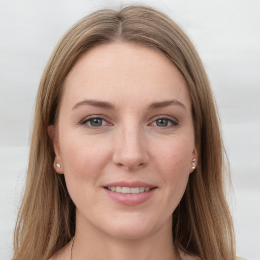 Joyful white young-adult female with long  brown hair and grey eyes