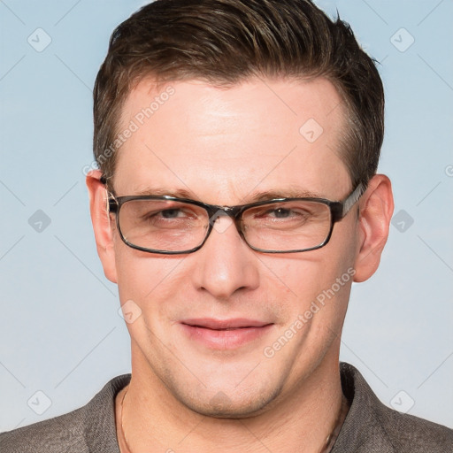 Joyful white adult male with short  brown hair and grey eyes