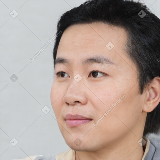 Joyful asian young-adult male with short  black hair and brown eyes