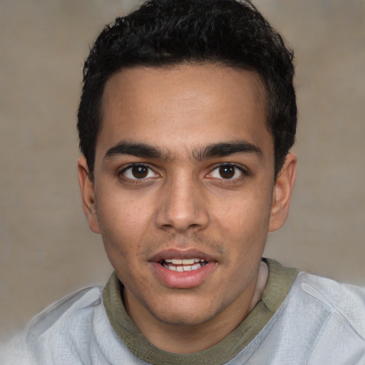 Joyful white young-adult male with short  black hair and brown eyes