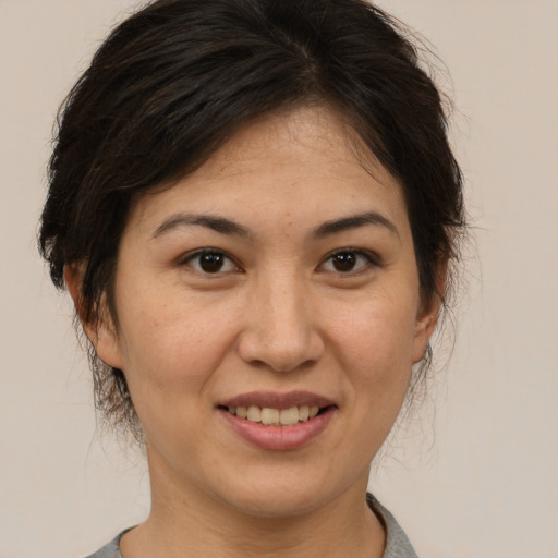 Joyful white adult female with medium  brown hair and brown eyes