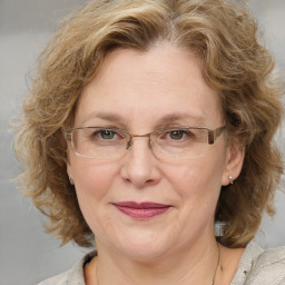 Joyful white adult female with medium  brown hair and blue eyes