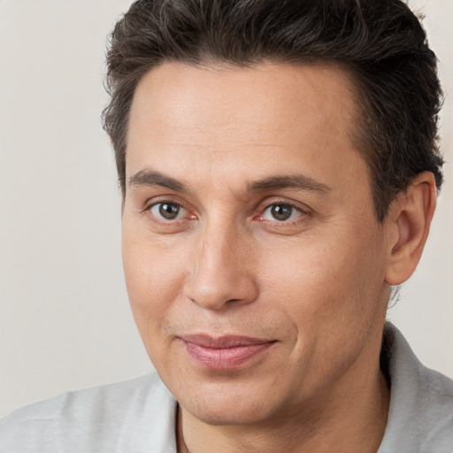 Joyful white adult male with short  brown hair and brown eyes