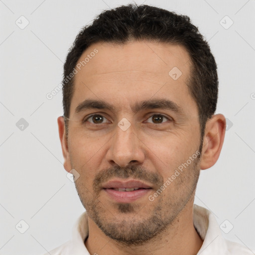 Joyful white adult male with short  black hair and brown eyes