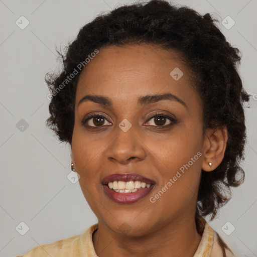 Joyful black young-adult female with long  brown hair and brown eyes