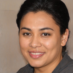 Joyful latino young-adult female with medium  brown hair and brown eyes