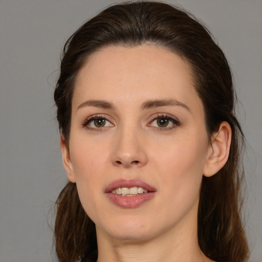 Joyful white young-adult female with medium  brown hair and brown eyes