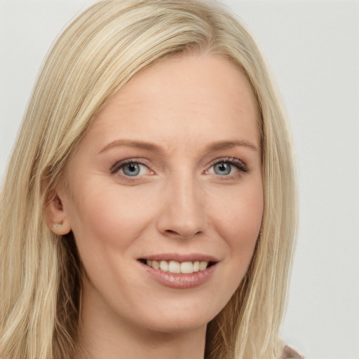 Joyful white young-adult female with long  brown hair and blue eyes