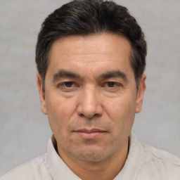 Joyful white adult male with short  black hair and brown eyes