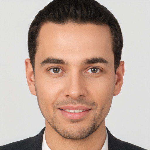 Joyful white young-adult male with short  brown hair and brown eyes