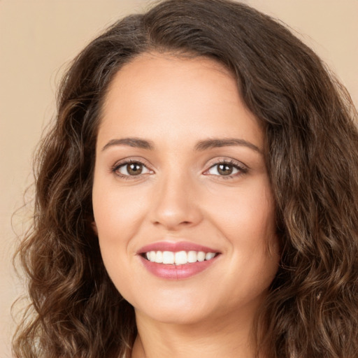 Joyful white young-adult female with long  brown hair and brown eyes