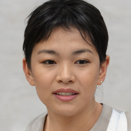 Joyful asian child female with short  brown hair and brown eyes