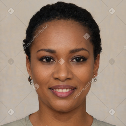 Joyful black young-adult female with short  black hair and brown eyes