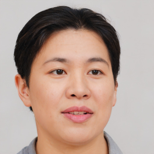 Joyful asian adult female with short  brown hair and brown eyes