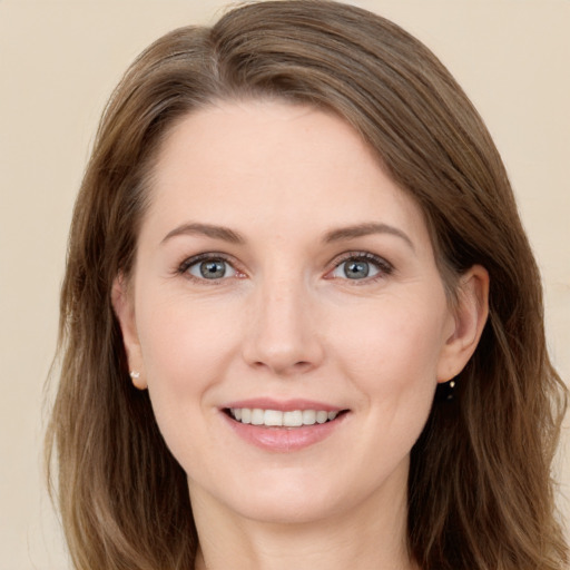 Joyful white young-adult female with long  brown hair and grey eyes