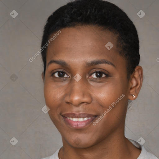 Joyful black young-adult female with short  black hair and brown eyes