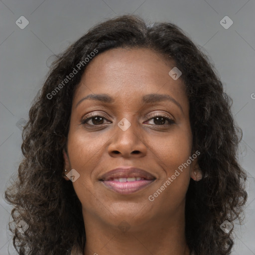 Joyful black young-adult female with long  brown hair and brown eyes