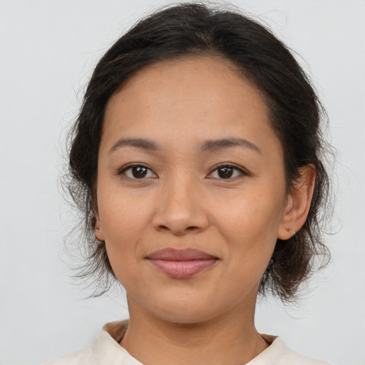 Joyful asian young-adult female with medium  brown hair and brown eyes