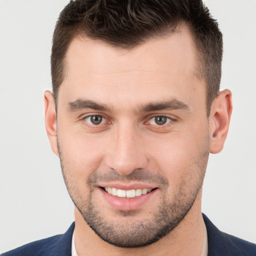 Joyful white young-adult male with short  brown hair and brown eyes