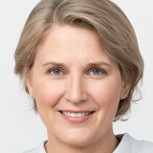 Joyful white adult female with medium  brown hair and grey eyes