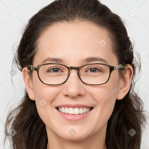 Joyful white young-adult female with long  brown hair and brown eyes