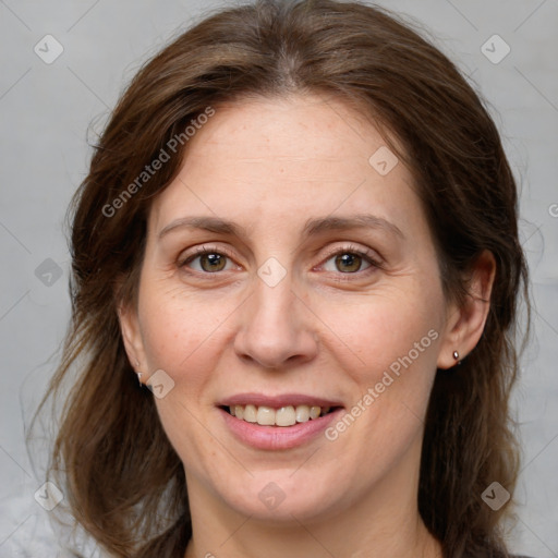 Joyful white adult female with medium  brown hair and grey eyes