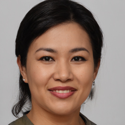 Joyful asian young-adult female with medium  black hair and brown eyes