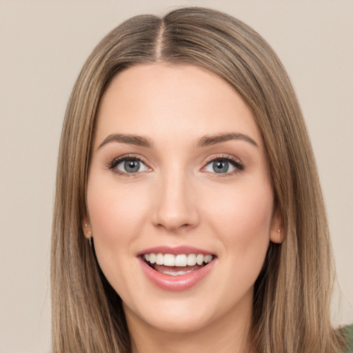 Joyful white young-adult female with long  brown hair and green eyes