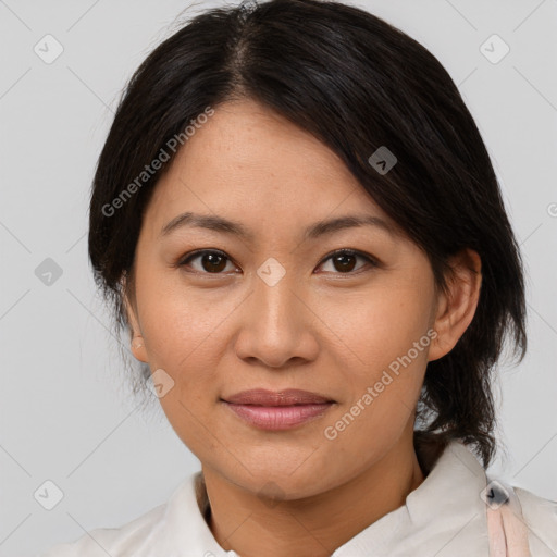 Joyful asian adult female with medium  brown hair and brown eyes