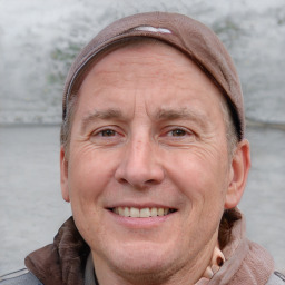 Joyful white adult male with short  brown hair and grey eyes