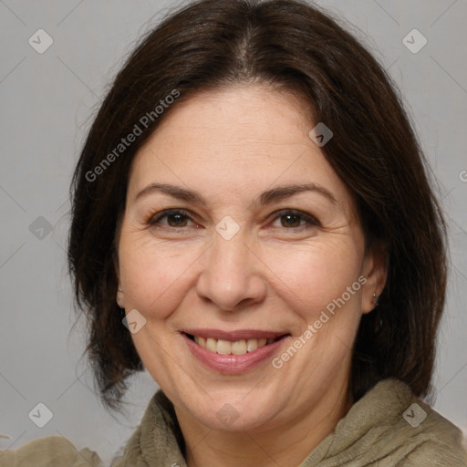 Joyful white adult female with medium  brown hair and brown eyes