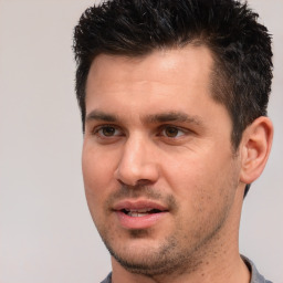 Joyful white young-adult male with short  black hair and brown eyes