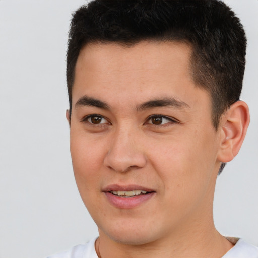 Joyful latino young-adult male with short  brown hair and brown eyes