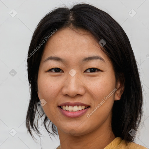 Joyful asian young-adult female with medium  brown hair and brown eyes