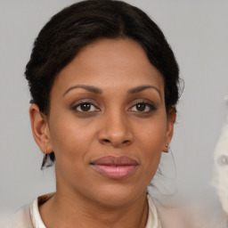 Joyful black young-adult female with medium  brown hair and brown eyes