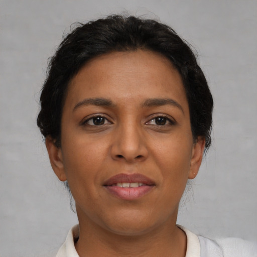 Joyful latino young-adult female with short  brown hair and brown eyes
