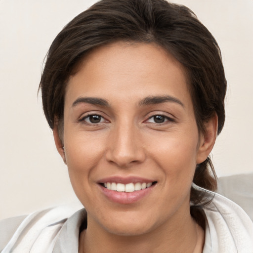 Joyful white young-adult female with medium  brown hair and brown eyes