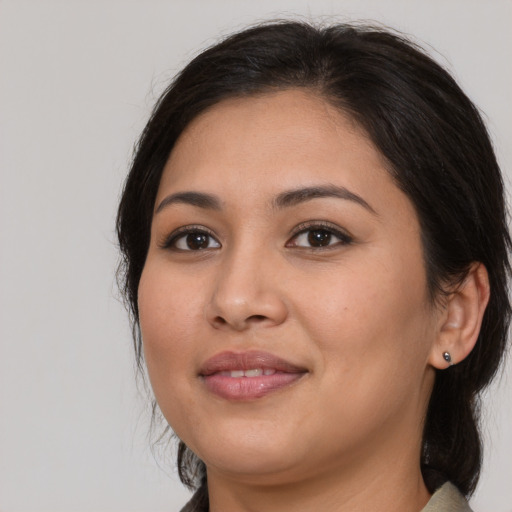 Joyful latino young-adult female with medium  brown hair and brown eyes