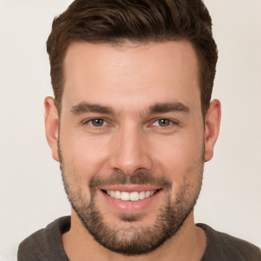 Joyful white young-adult male with short  brown hair and brown eyes